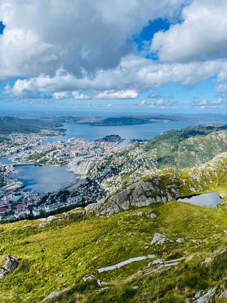 Discover the breathtaking aerial view of Bergen, Norway, showcasing lush landscapes and serene waters under a vibrant sky.