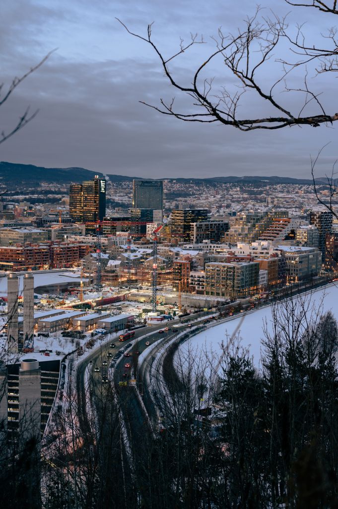 A breathtaking aerial winter view of Oslo's cityscape with snow-covered buildings and roads.