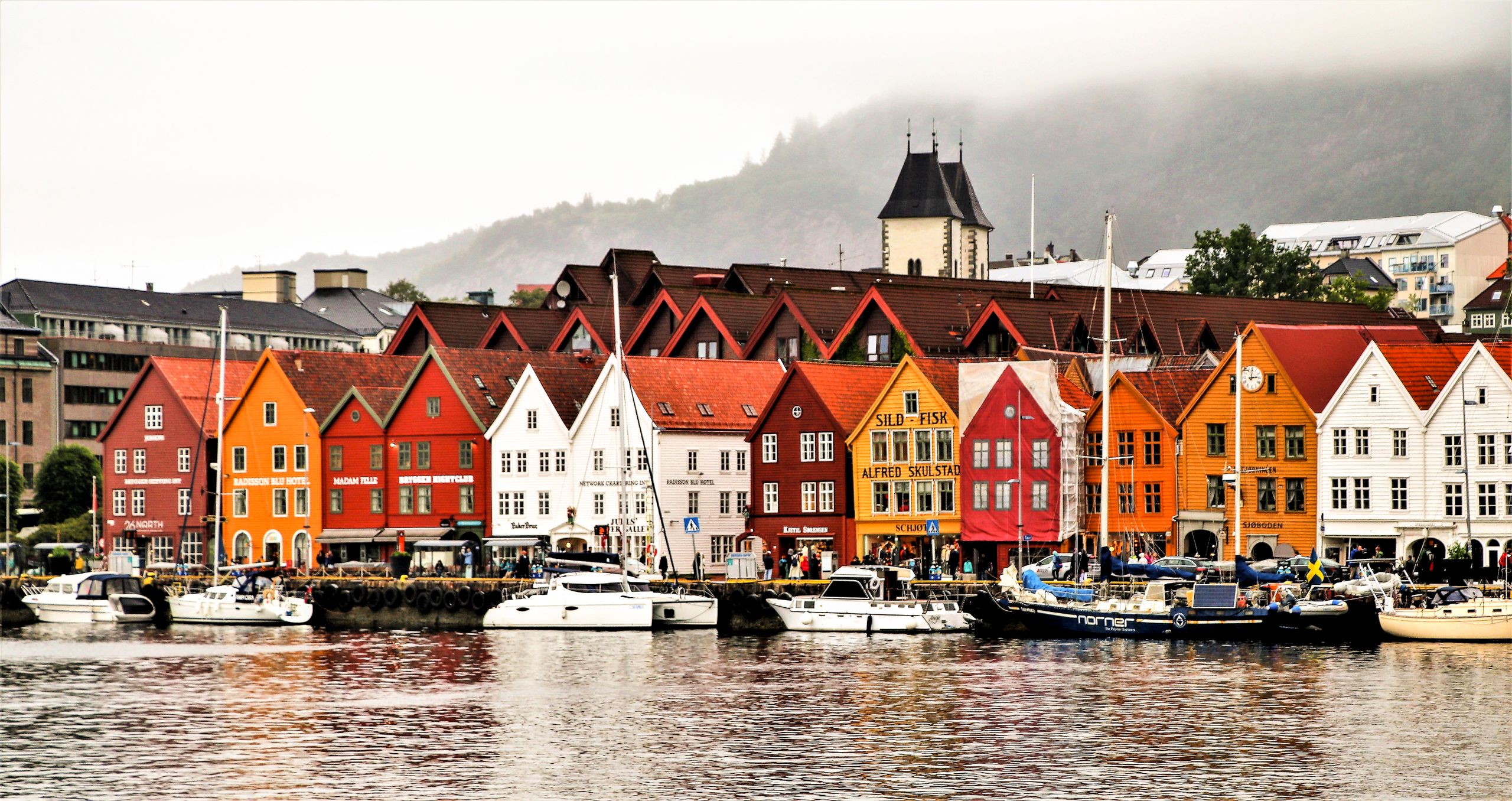 Charming waterfront of Bergen showcasing vibrant historic buildings and boats. Things to do in Bergen Norway