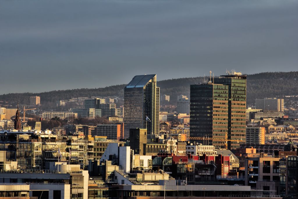 Vibrant city skyline at dusk showcasing modern architecture and skyscrapers under a dramatic sky.